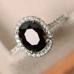 SILVER OVAL SHAPED ONYX / WHITE TOPAZ HALO RING